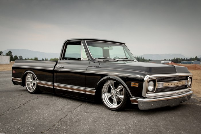 Black Chevrolet C10 pickup truck with custom wheels