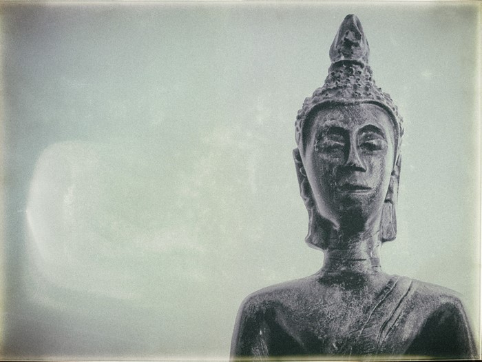 Buddha statue against a light background
