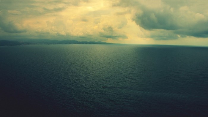 Ocean and Cloudy Sky Over Coastline