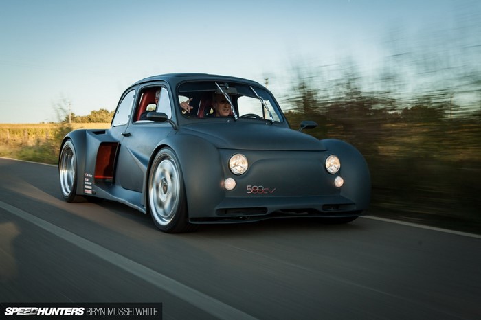 Modified Fiat 500e EV sports car driving on a road