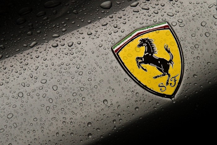 Ferrari logo on a wet car surface