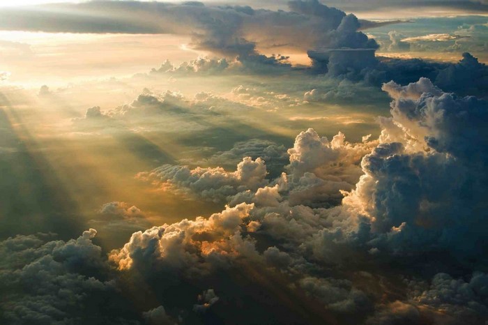 Sunlight beams through dramatic clouds at sunset