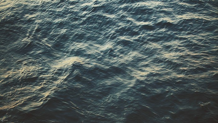 Ocean waves with sunlight reflection