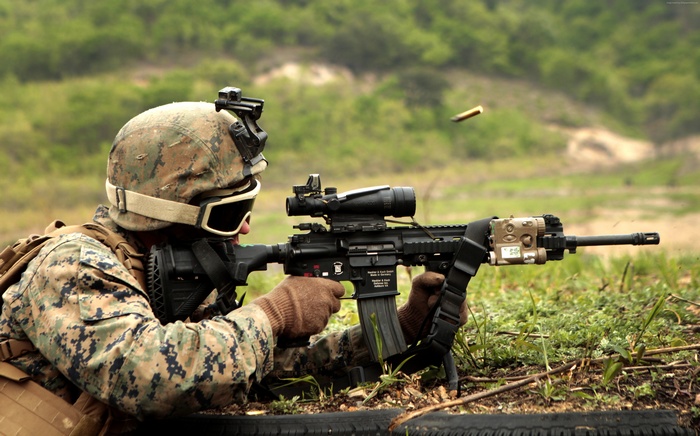 Soldier firing an HK416 assault rifle