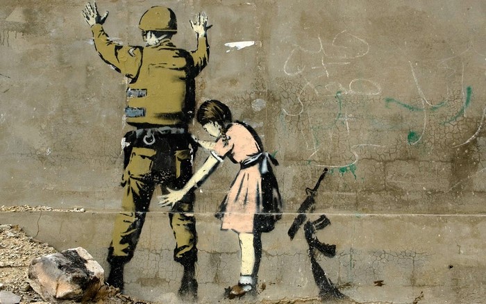Girl confronting soldier with rifle graffiti