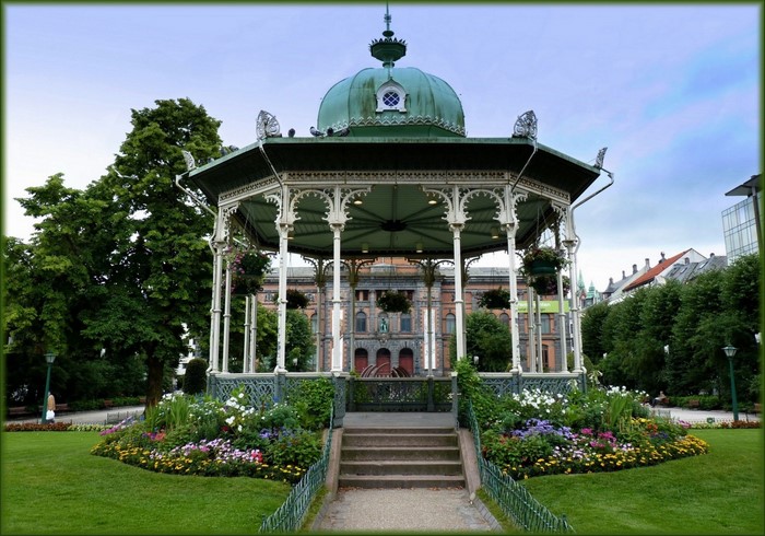 Gazebo in a park with a building in the background