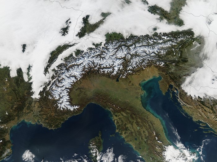Satellite view of the Alps with snow and clouds
