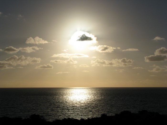 Sunset over the ocean with clouds