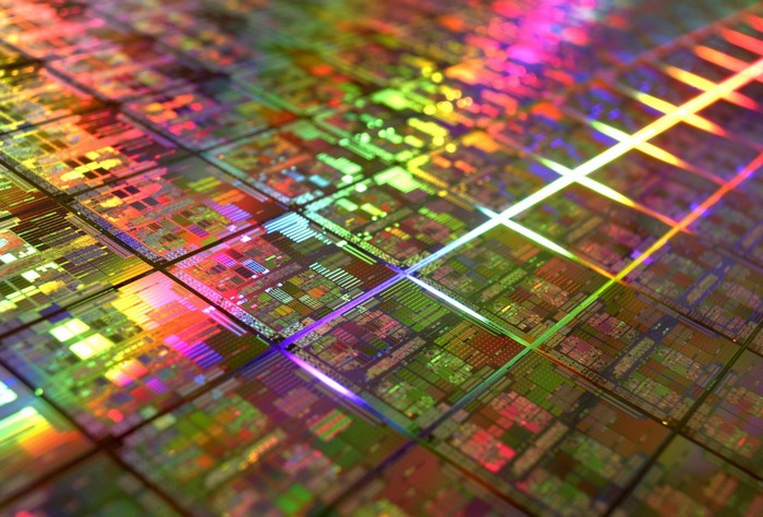 Colorful silicon wafer with intricate patterns and reflections