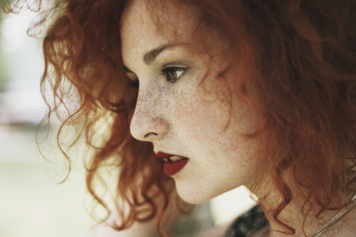 Close up portrait of a redhead woman with freckles