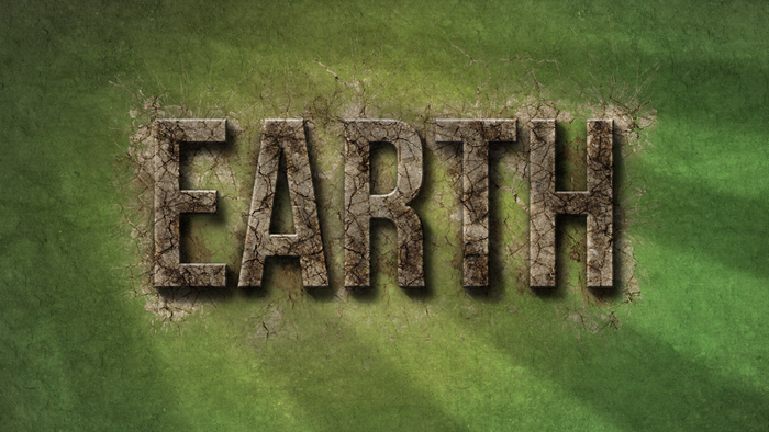 The word EARTH made of cracked stone on a green textured background