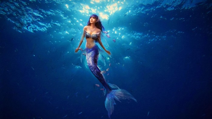 Mermaid swimming in the ocean with fish