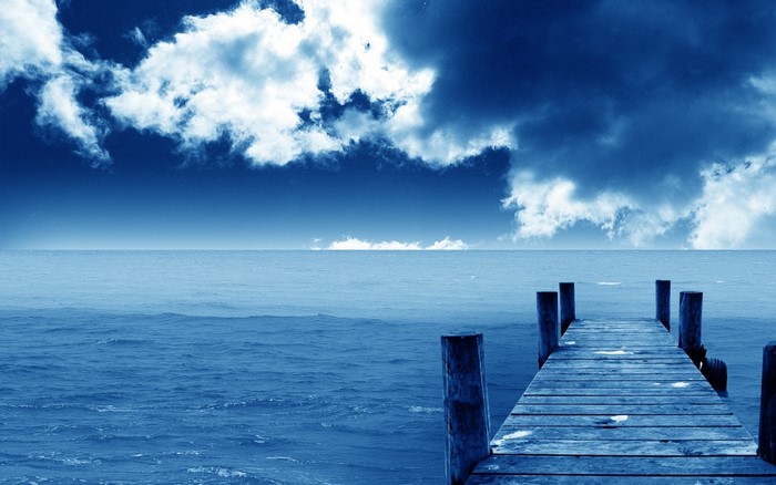 Wooden pier on the sea under a cloudy sky