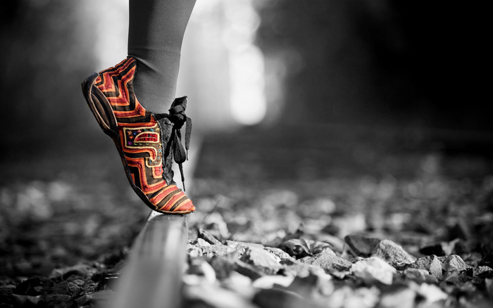 Footwear on a railway track with selective coloring