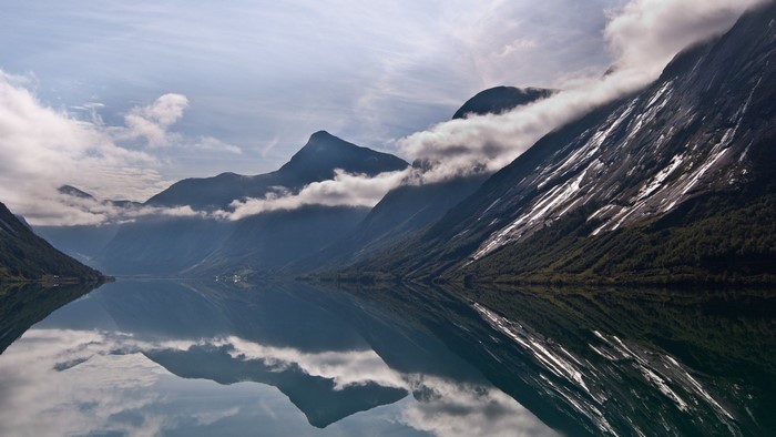 Mountain lake reflection with clouds