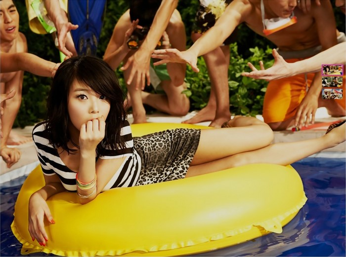 Woman in pool with inflatable ring and men around her