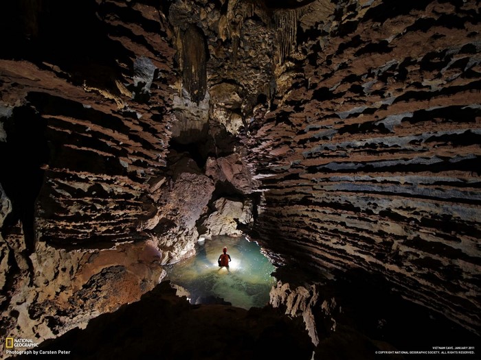 Cave explorer in Vietnam cave with National Geographic logo