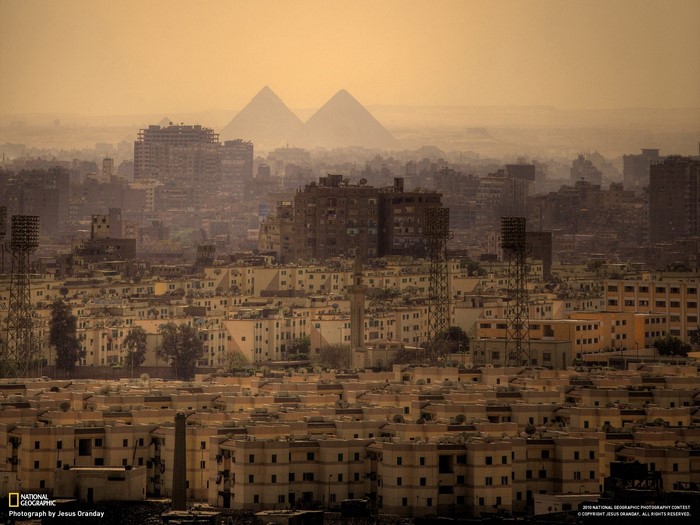 Cairo cityscape with pyramids in the distance