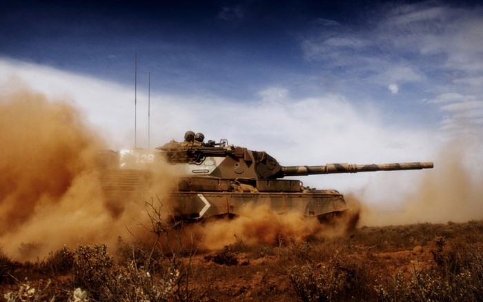 Leopard 1 tank driving through dust