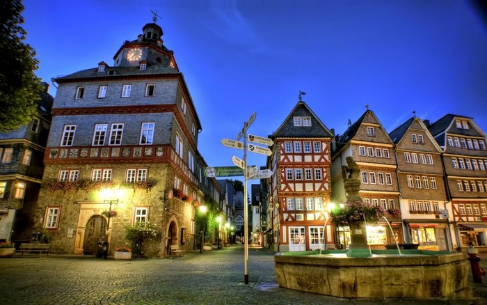 Herborn Cityscape at Night with Fountain and Signpost
