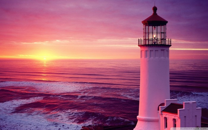 Lighthouse at Sunset Over Calm Ocean