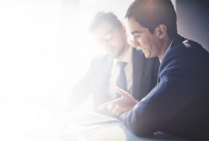 Two businessmen looking at a tablet