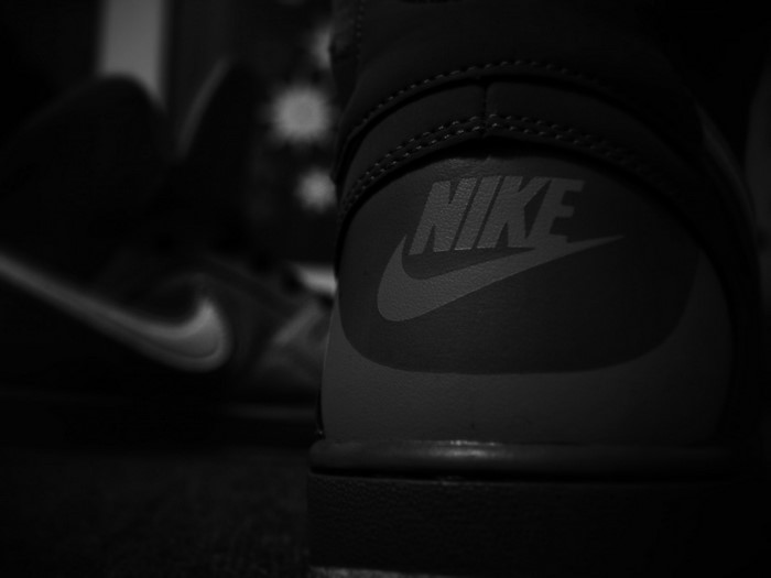Close-up of a Nike shoe logo in monochrome