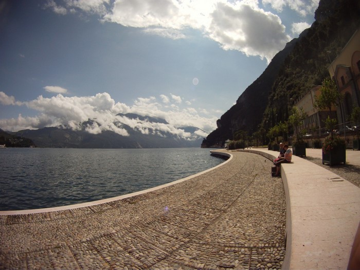 Scenic lakefront with mountains and clouds