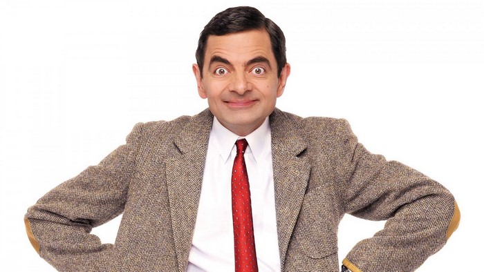 Rowan Atkinson as Mr. Bean wearing a suit and tie