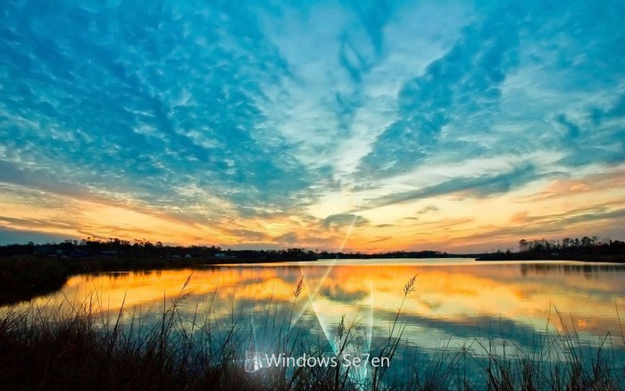 Sunset over a lake with reflections and clouds