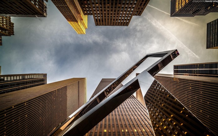 Worm's eye view of skyscrapers and a modern sculpture