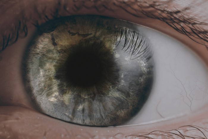 Extreme Close-up of a Human Eye with World Map Reflection