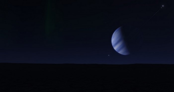 Planet and moons in dark sky