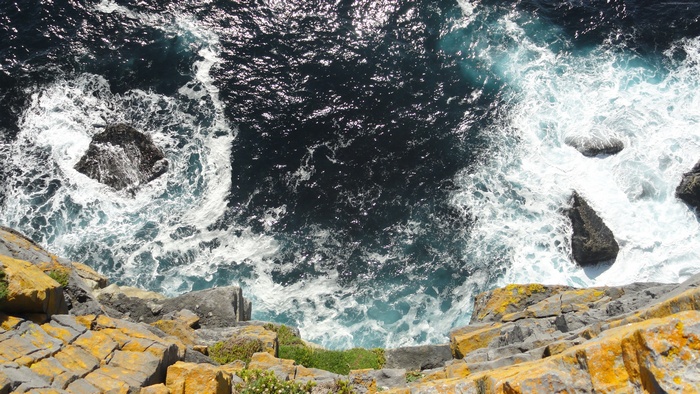 Ocean waves crashing on rocky cliffs