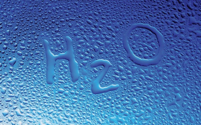 H2O text formed by water droplets on a blue surface