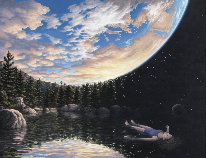 Person floating in water with Earth and stars in the background