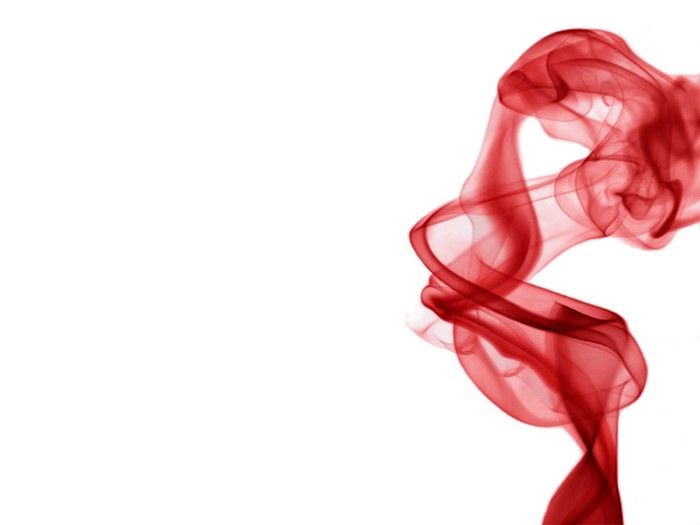 Red smoke swirling against a white background