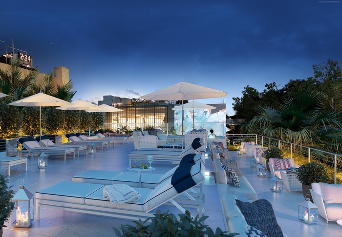 Rooftop lounge with sunbeds and umbrellas at night