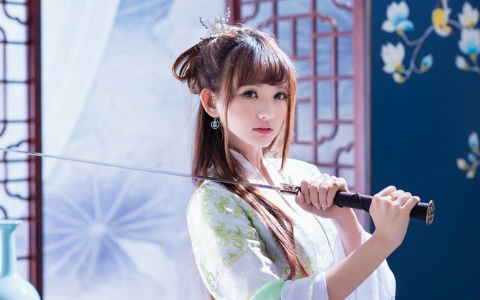 Woman in traditional Japanese attire holding a katana