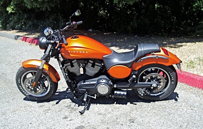 Orange Victory Judge motorcycle parked on asphalt