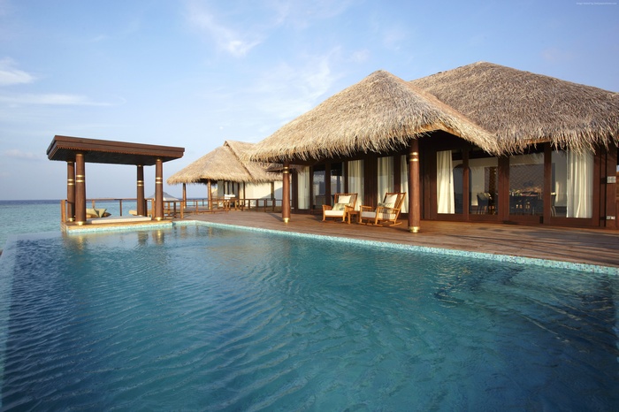 Overwater bungalows with infinity pool at Anantara Kihavah Villas, Maldives