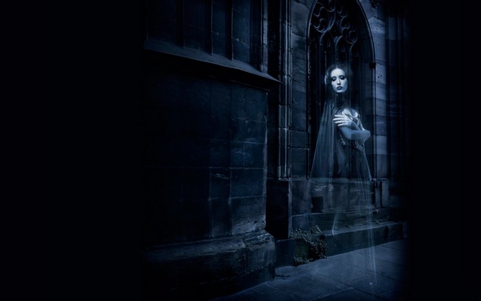 Ghostly woman in gothic architecture at night
