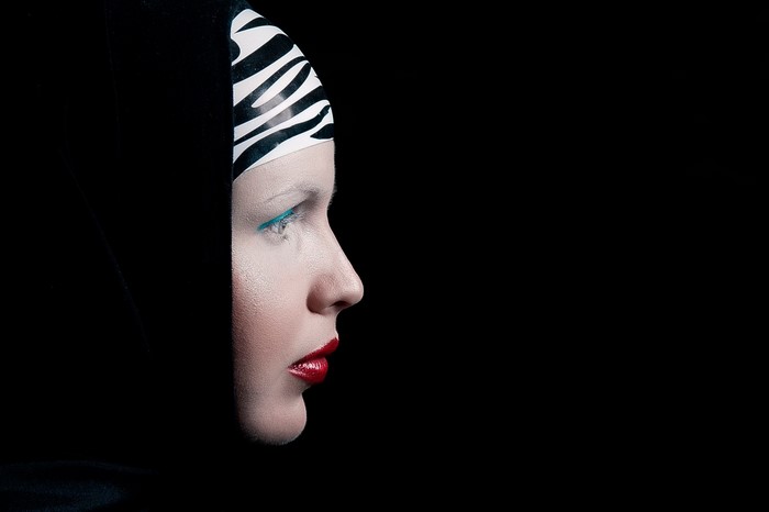 Woman with zebra print headwear and dramatic makeup