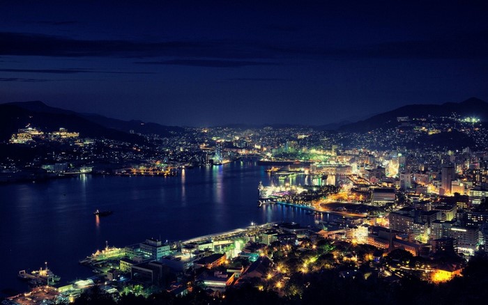 Cityscape at night with harbor and lights