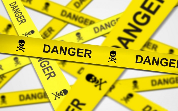 Yellow danger tape with skull and crossbones