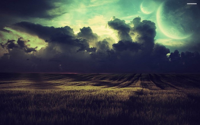 Planets and clouds over a field at dusk
