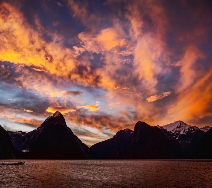Mountains and lake at sunset with colorful clouds