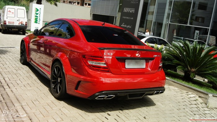 Red Mercedes-Benz C63 AMG Coupe parked outside dealership
