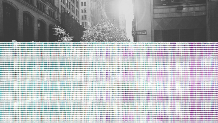 Black and white city street with one way sign
