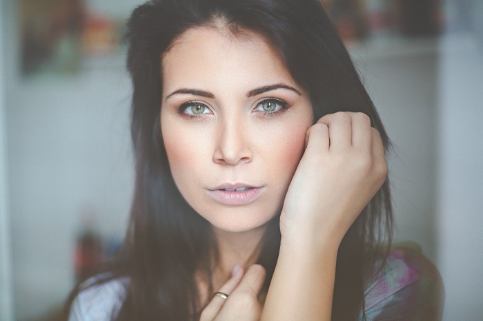 Woman with long dark hair and green eyes